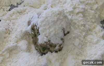 Cover blob of meat with flour for greek recipe keftedes kalokairinoi summer meatballs.