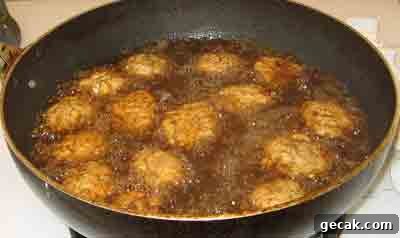 Frying the summer meatballs for greek recipe keftedes kalokairinoi