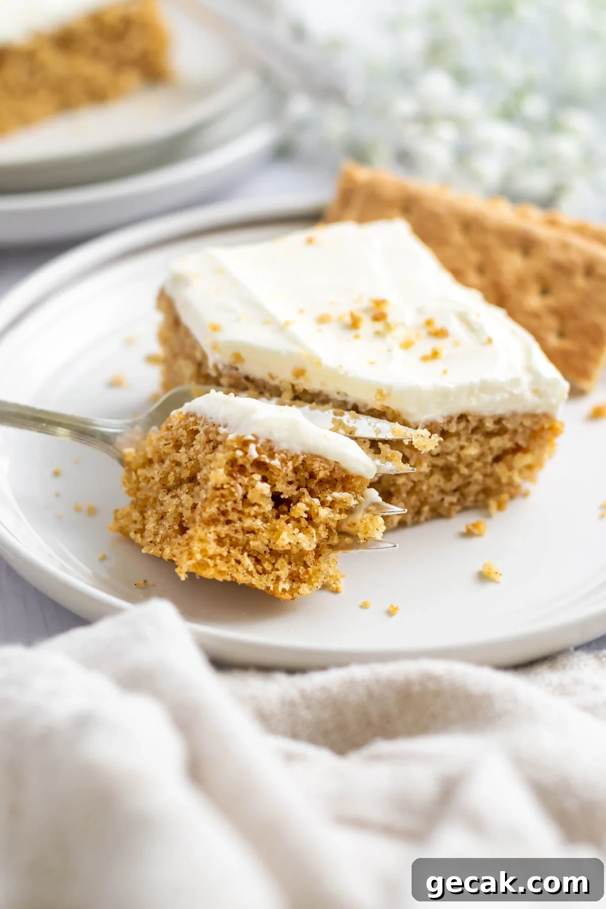 No-Bake Graham Cracker Cake Recipe: Layered Dessert with Creamy Filling 2 fork with a bite of graham cracker cake