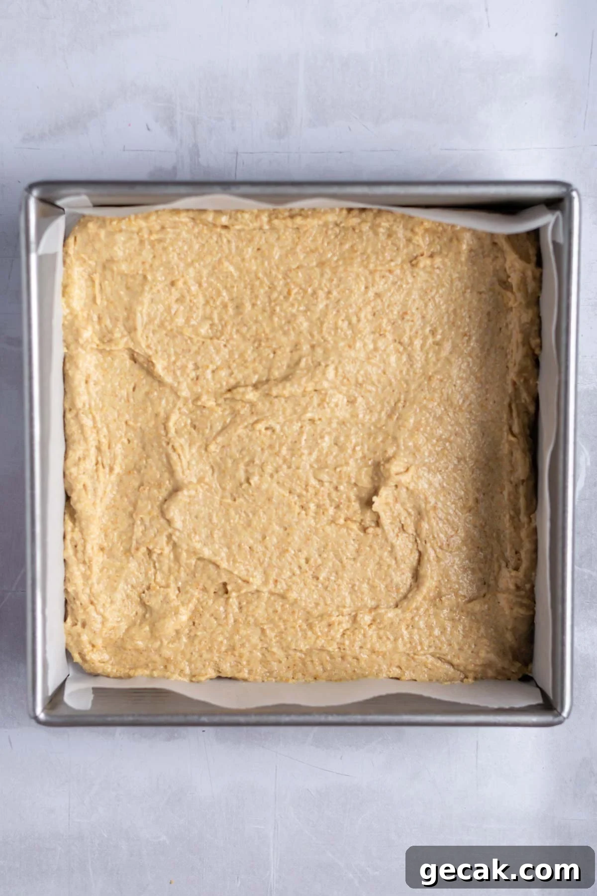 No-Bake Graham Cracker Cake Recipe: Layered Dessert with Creamy Filling 11 cake batter in a parchment lined baking tin