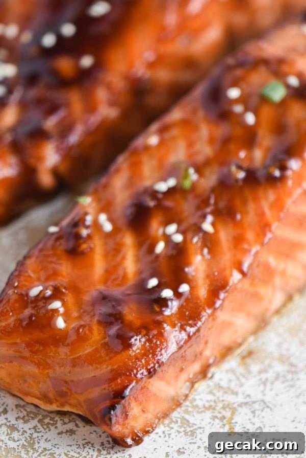 Air fryer teriyaki salmon fillets on a speckled plate.