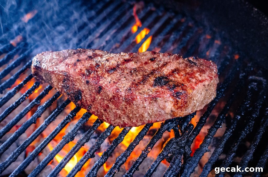 Steak over a charcoal grill.