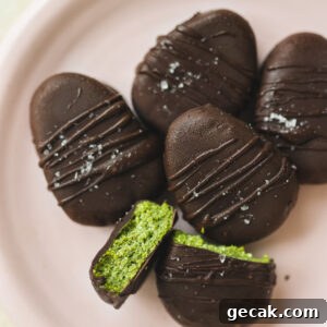 a pink plate filled with chocolate peanut butter vegan easter eggs with one cut down the middle to show the filling