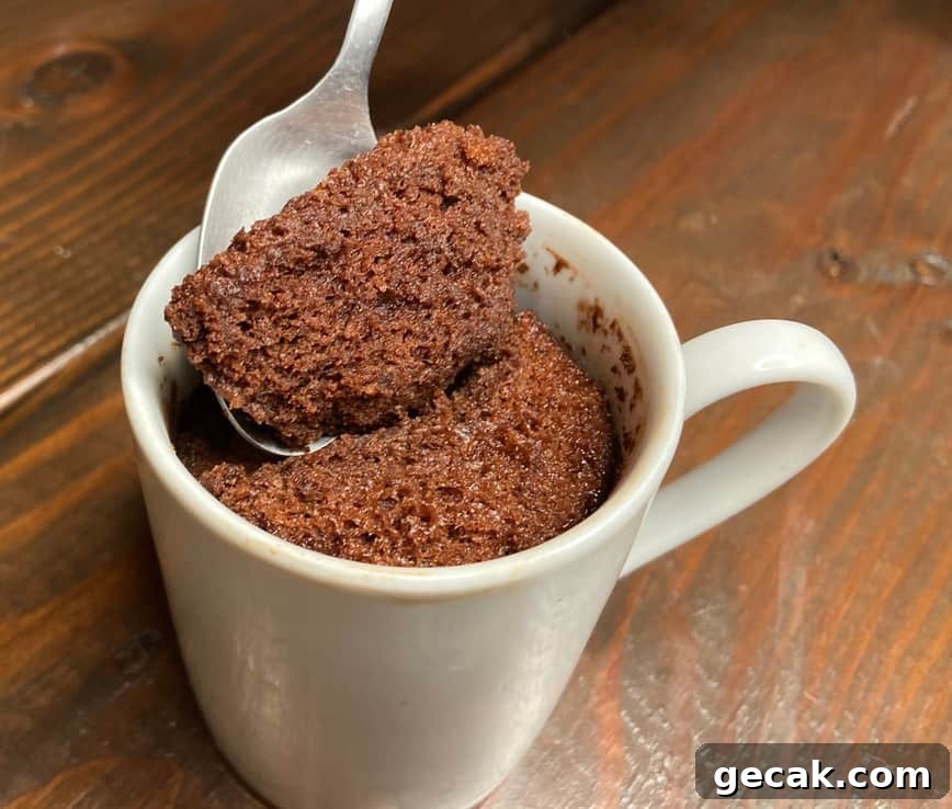 Taking a spoonful of cake from a mug.
