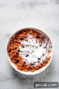 Chocolate Peanut Butter Muddy Buddies Snack Mix Recipe 6 Powdered sugar dumped in a bowl of coated cereal.