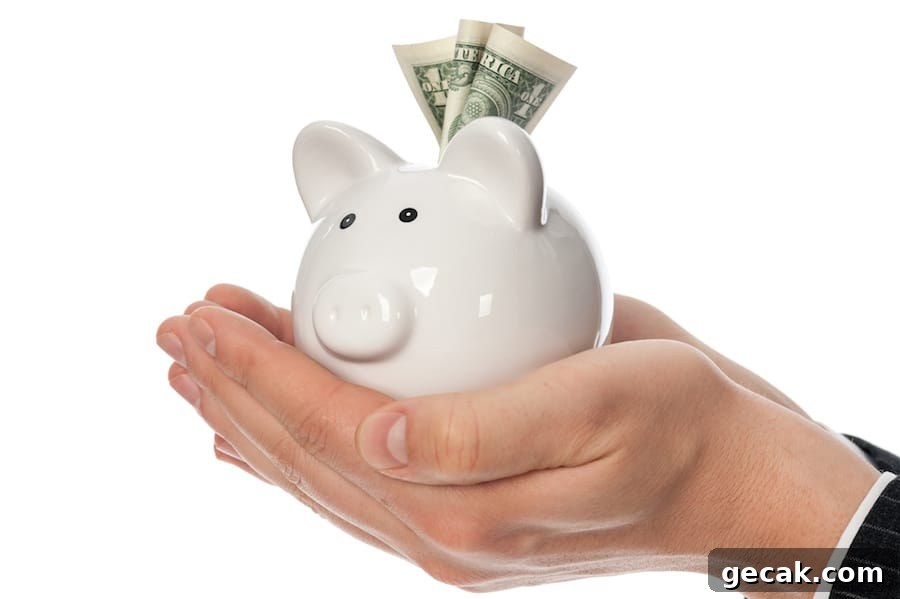 Image shows two hands cupped, holding a white ceramic piggy bank with a dollar sticking out.