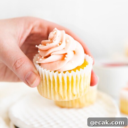 hand picking up rhubarb cupcake