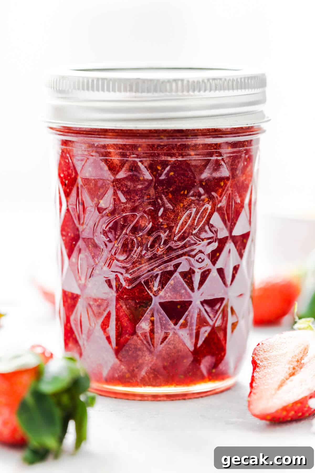 Homemade Strawberry Jam Recipe: Small-Batch Method for Fresh Flavor 2 straight ahead super close up at a jar of homemade strawberry jam with the lid on