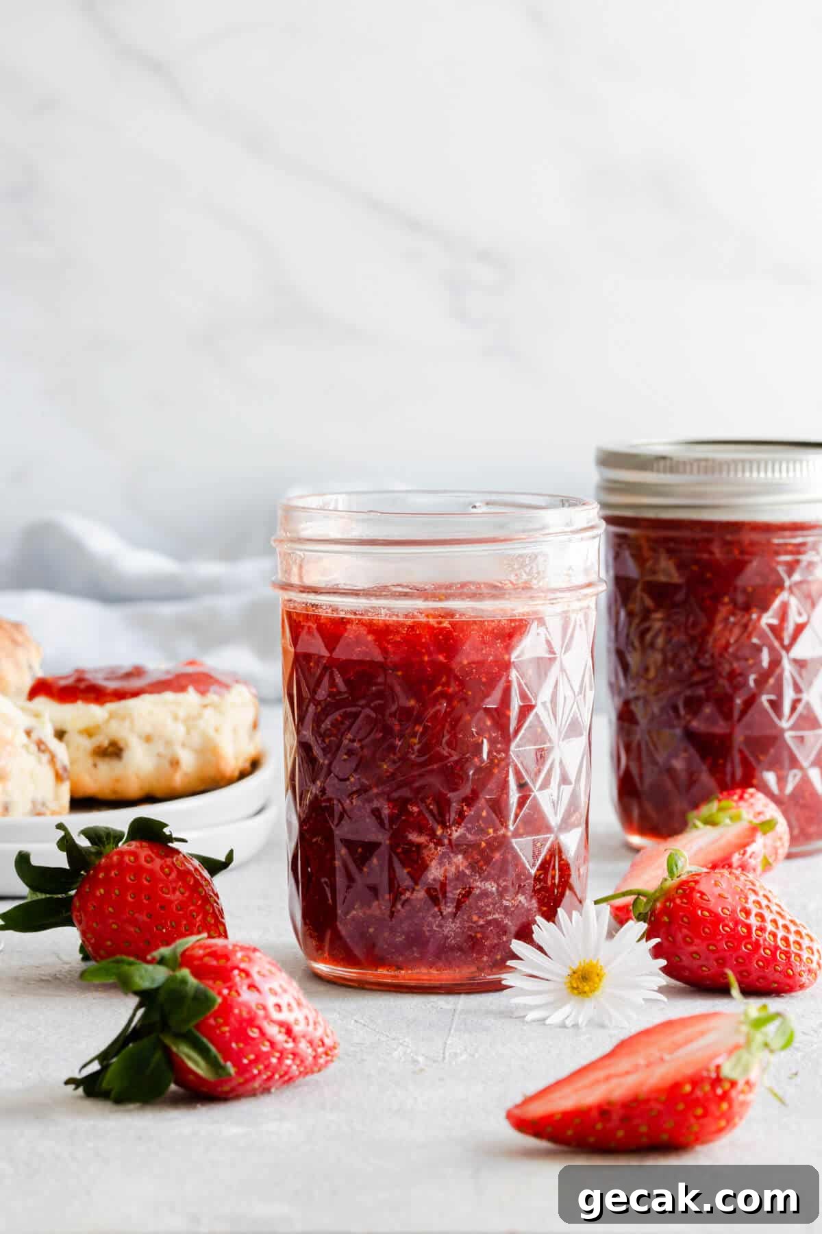 Homemade Strawberry Jam Recipe: Small-Batch Method for Fresh Flavor 12 straight ahead shot of glass jar with jam inside and fresh strawberries around it