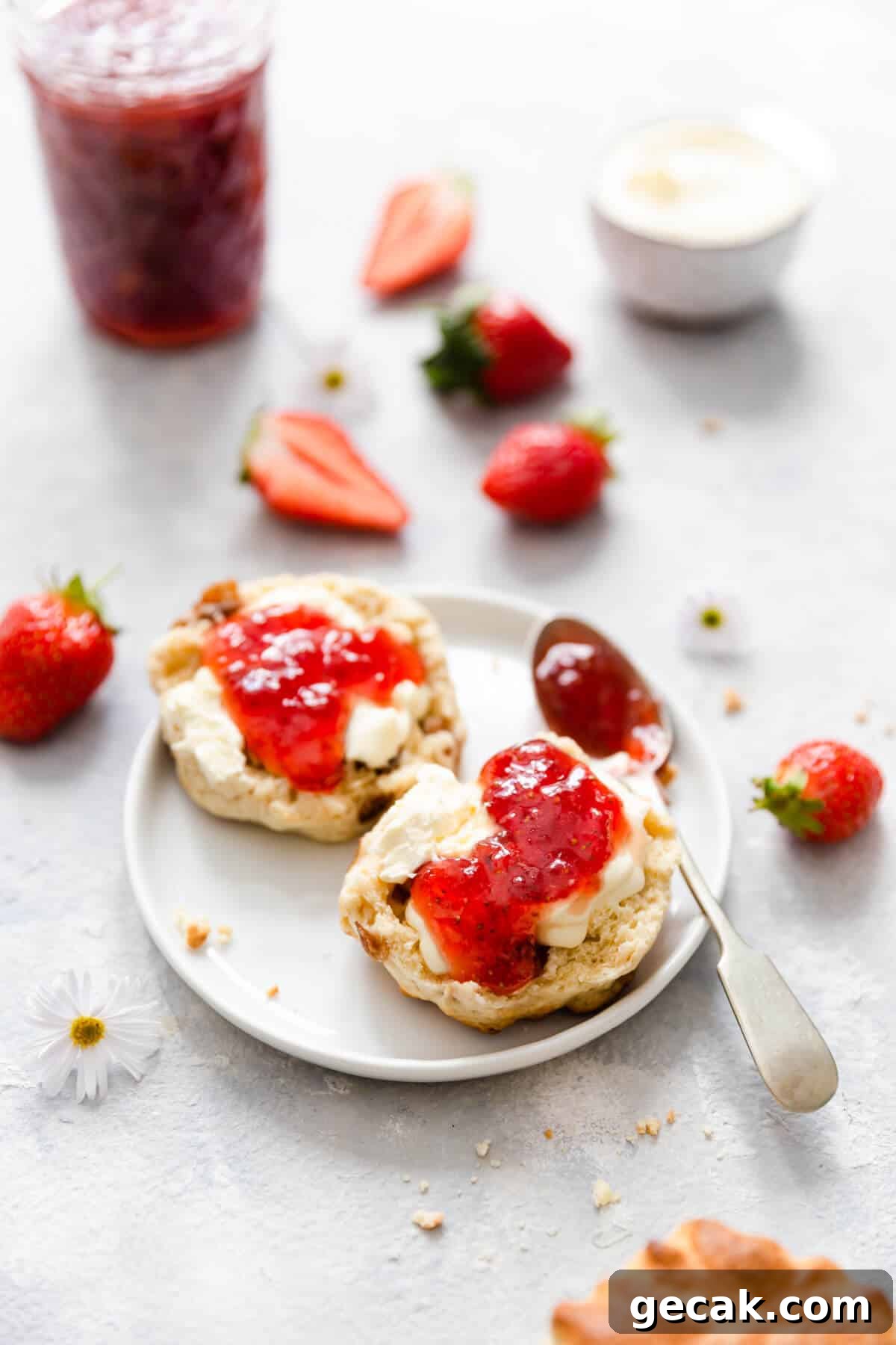 Homemade Strawberry Jam Recipe: Small-Batch Method for Fresh Flavor 13 top view of scone with cream and jam on a small white plate
