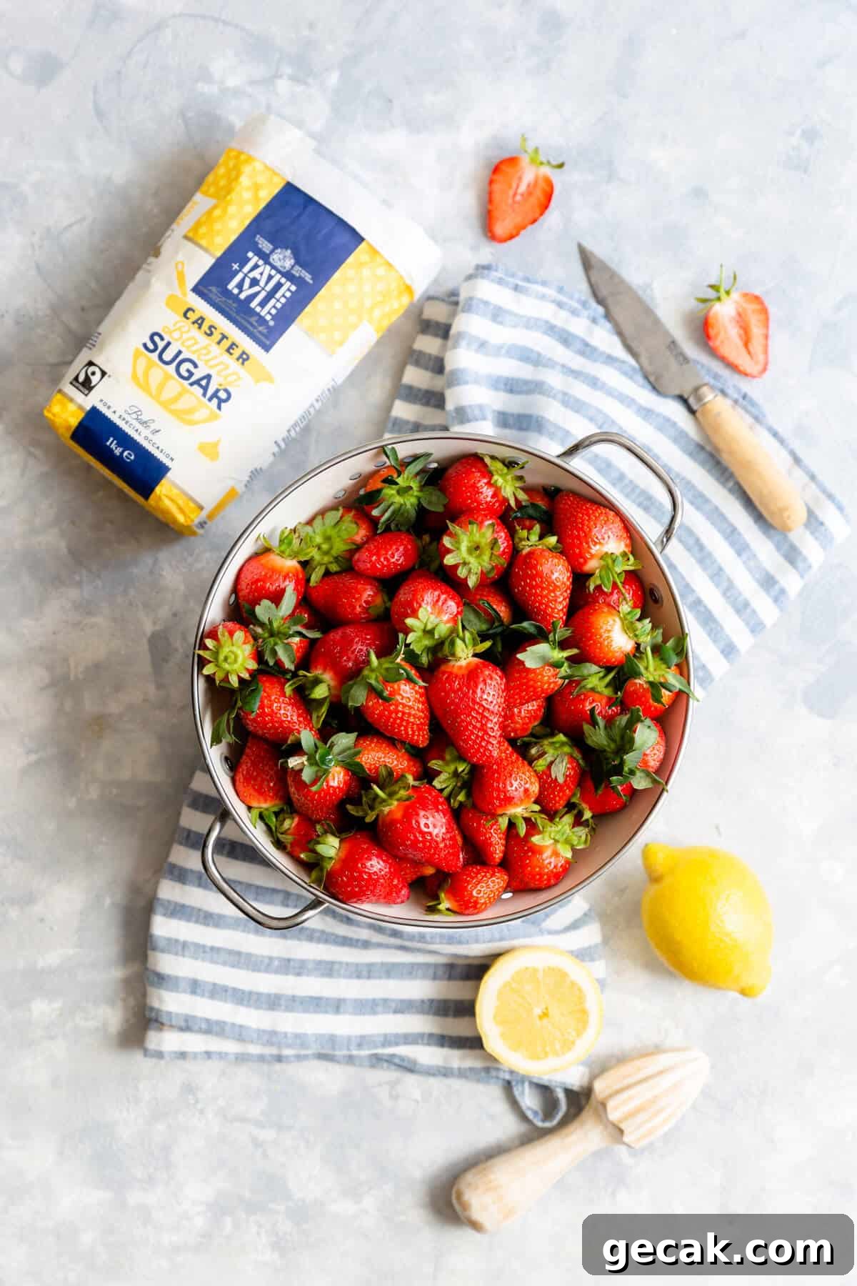 Homemade Strawberry Jam Recipe: Small-Batch Method for Fresh Flavor 6 top view at fresh strawberries in colander and some sugar and lemon on side