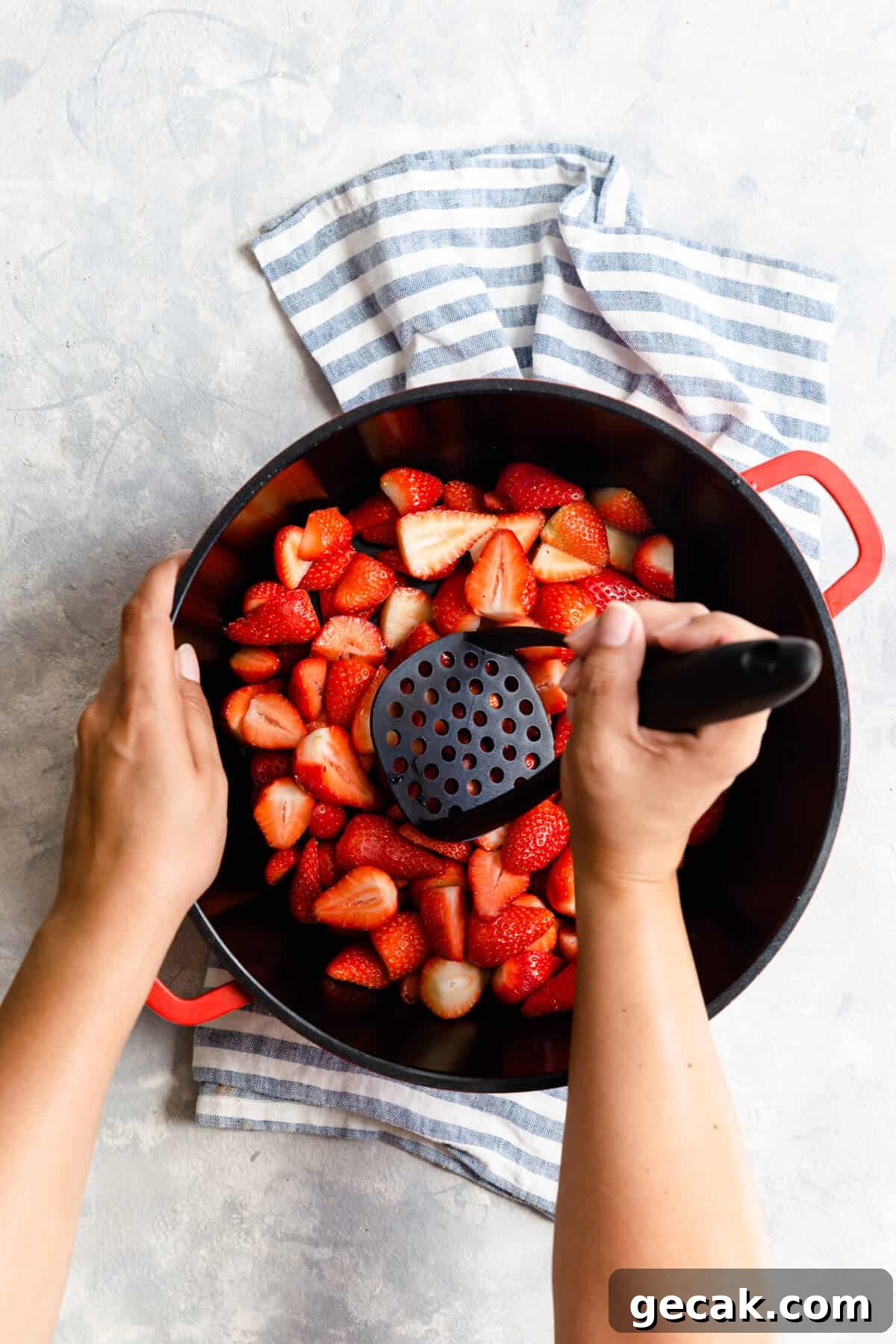 Homemade Strawberry Jam Recipe: Small-Batch Method for Fresh Flavor 9 top view of a person crushing strawberries with potato masher