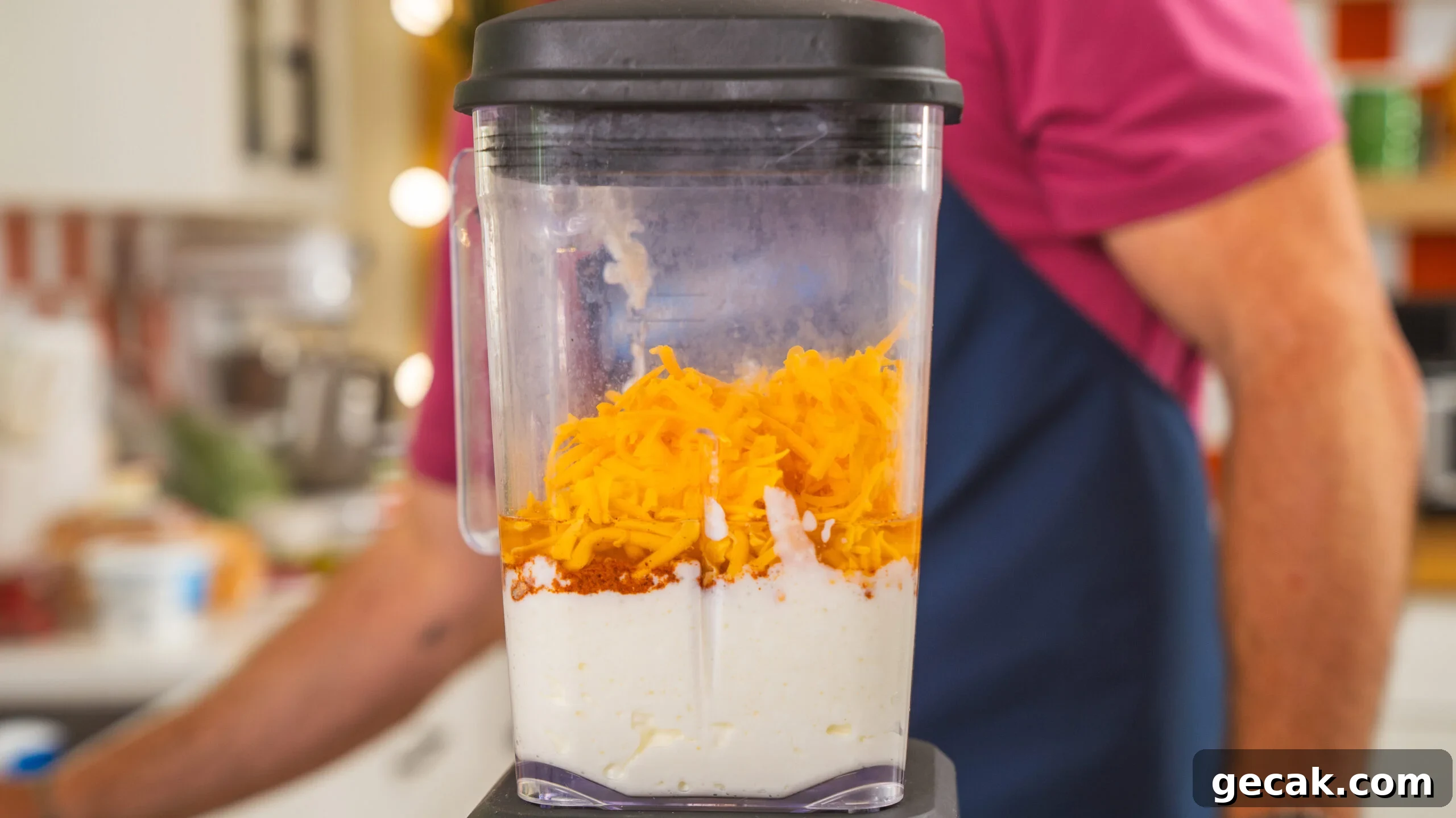 A blender filled with cheese, cottage cheese and spices—the beginning of a cottage cheese queso dip.