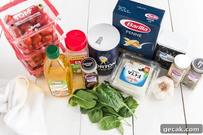 Cheesy Baked Penne Pasta with Crispy Breadcrumb Topping 3 The ingredients for the pasta dish are on a white surface.