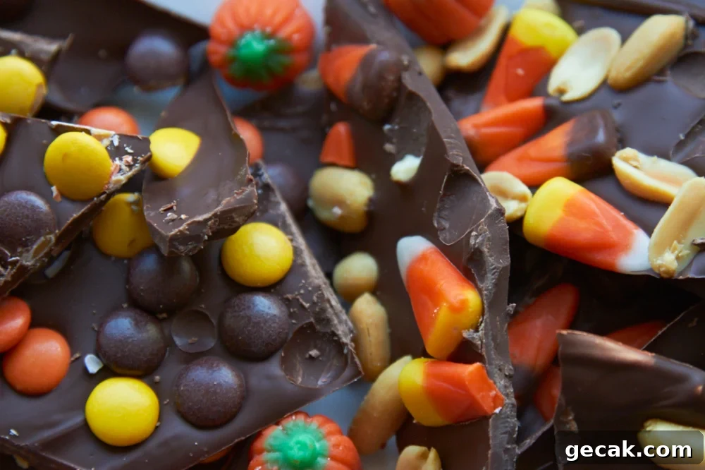 Halloween chocolate bark with candy corn, peanuts, and peanut butter candies.
