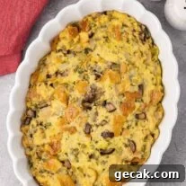 Classic Old-Fashioned Bread Stuffing Recipe for Thanksgiving 8 An oval casserole dish filled with old-fashioned bread stuffing made with sourdough bread, celery, onions, and mushrooms.