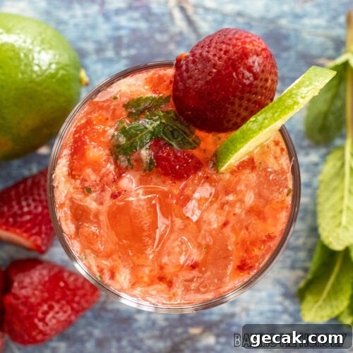 virgin strawberry mojito mocktail recipe garnished with a strawberry and lime slice from overhead