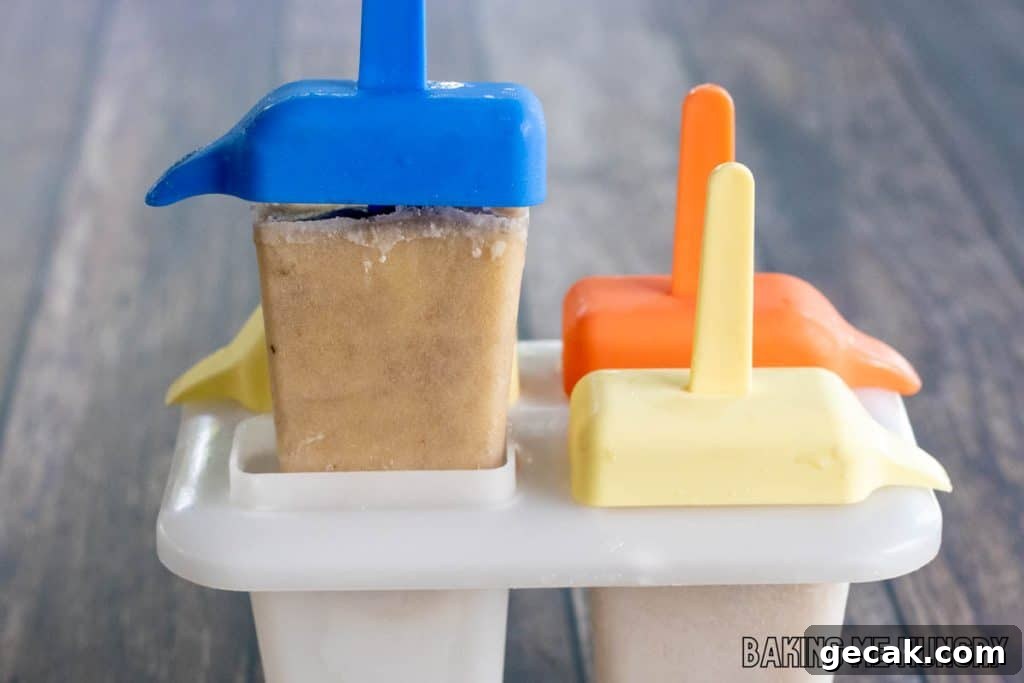 hand lifting an ice pop from mold