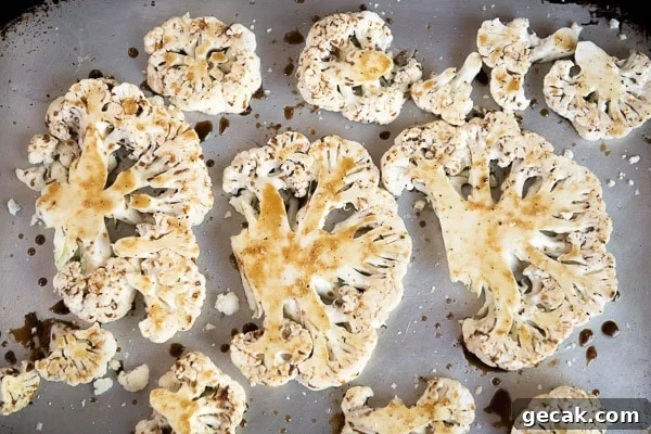 Parmesan-Roasted Cauliflower Steaks with Garlic and Herbs 7 Uncooked cauliflower steaks coated with marinade on sheet pan