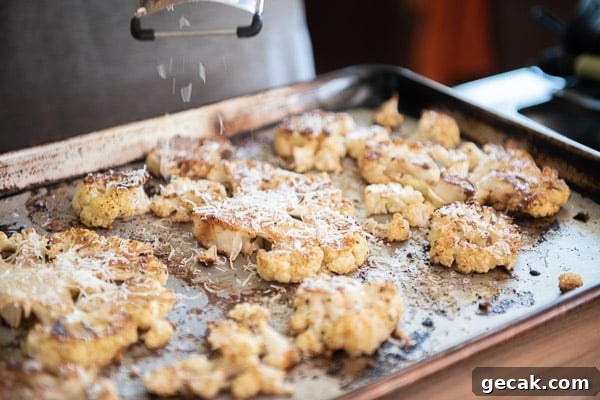 Parmesan-Roasted Cauliflower Steaks with Garlic and Herbs 9 Grating cheese over roasted cauliflower