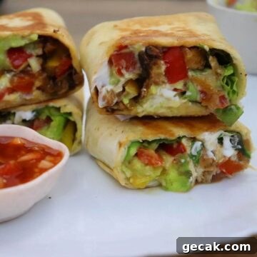 chicken fajita wrap. They are sliced and stacked on a white plate. Served with salsa dip.