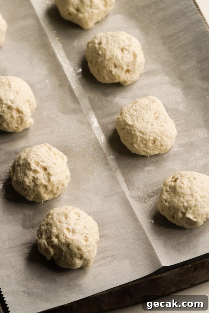 cream cheese stuffed bagel dough balls on a baking sheet