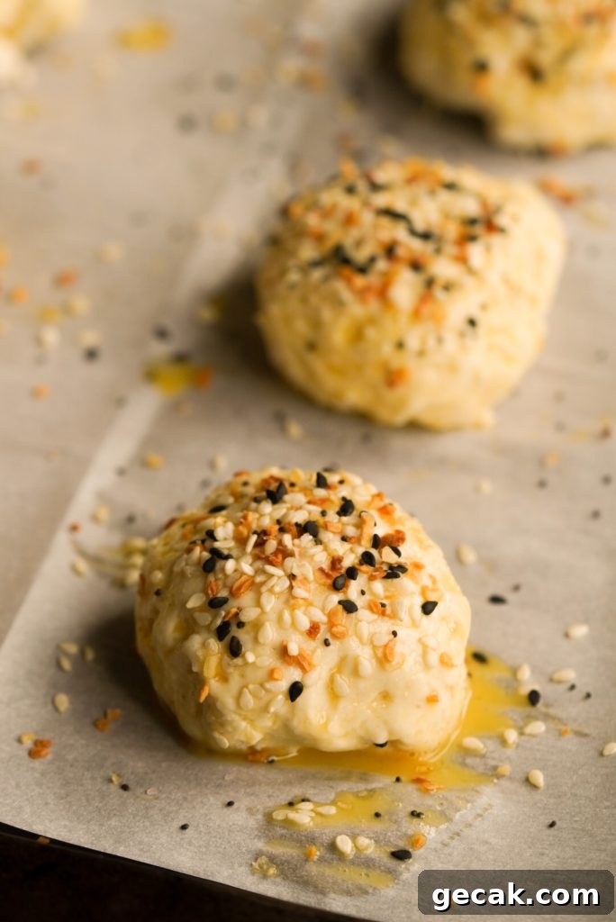 close up shot of a bagel bite dough ball with egg wash and everything seasoning before baking
