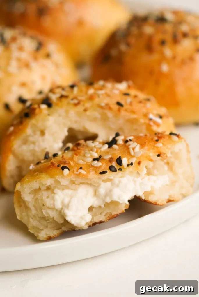 greek yogurt bagel bite cut in half with the inside cream cheese filling showing