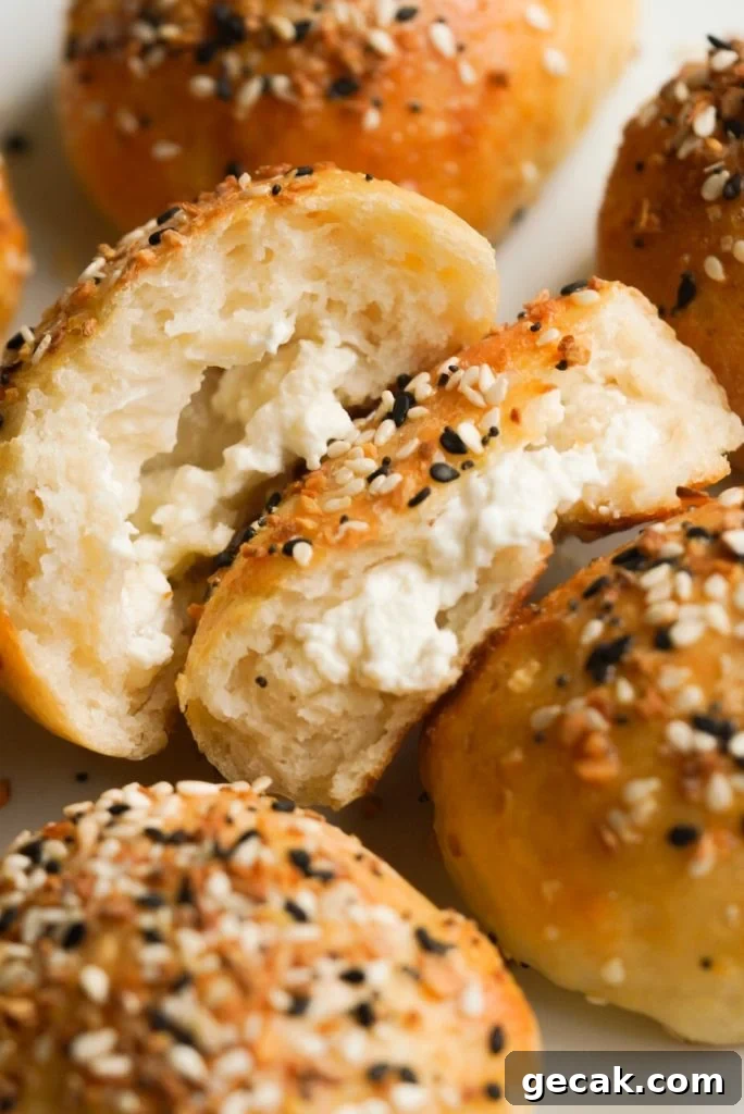 cream cheese stuffed bagel bites on a plate with one opened in half