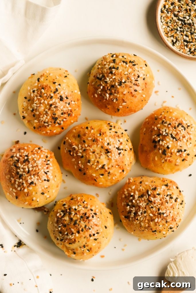 cream cheese greek yogurt bagel bites on a white plate with everything seasoning on the side