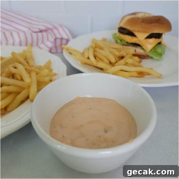 White bowl filled with In n Out Sauce next to a burger and fries