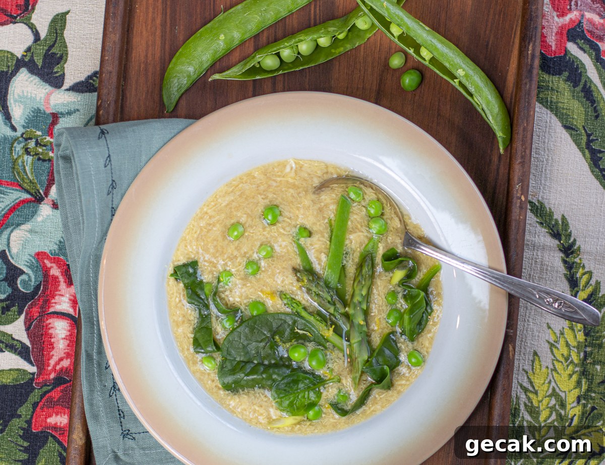 Spring egg drop soup with many green vegetables in a vintage bowl 
