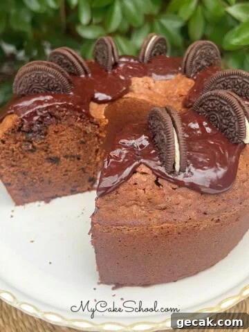 Chocolate Oreo Pound Cake, sliced, on a cake pedestal.