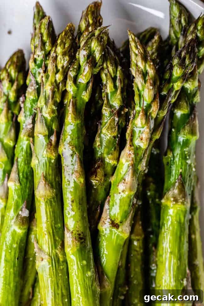 roasted asparagus on a white plate.