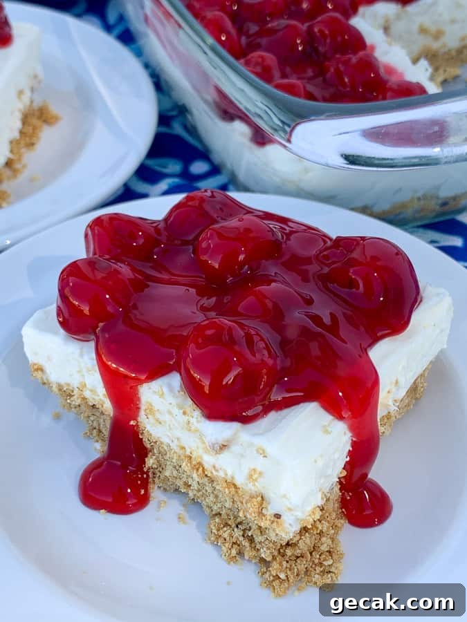 Pan of cherry delight dessert next to piece on a white plate