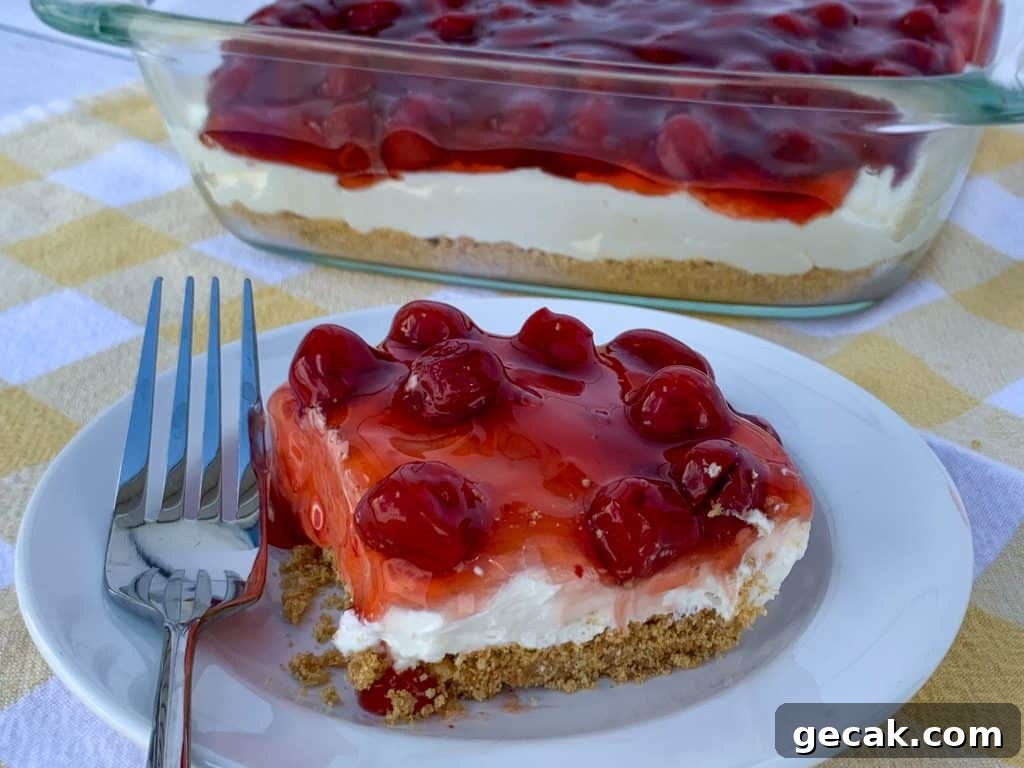 Cherry pie filling on piece of cherry delight next to 9" pan full