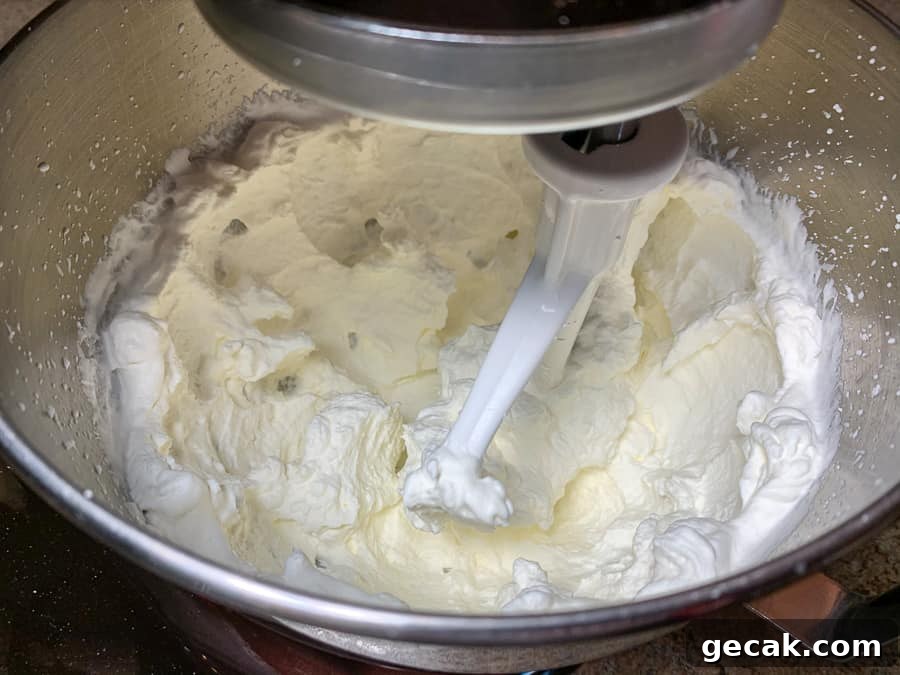 Beating whipping cream in an electric mixer bowl