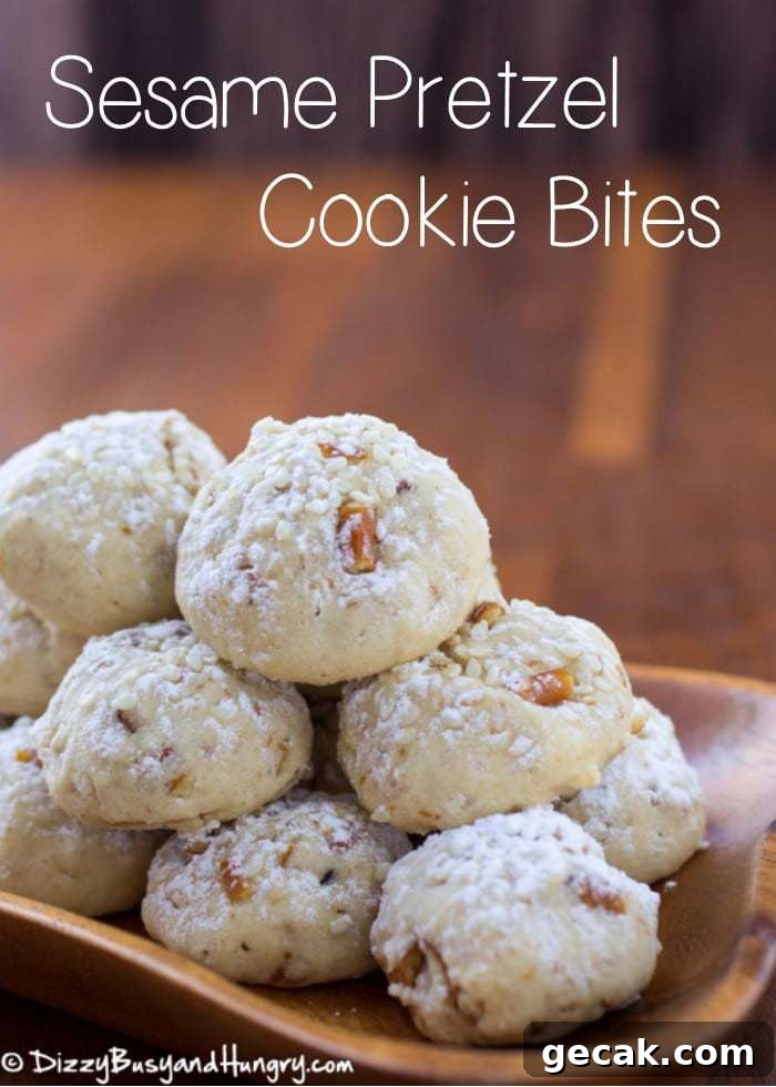 Side view of sesame pretzel cookie bites stacked in a wooden bowl. 