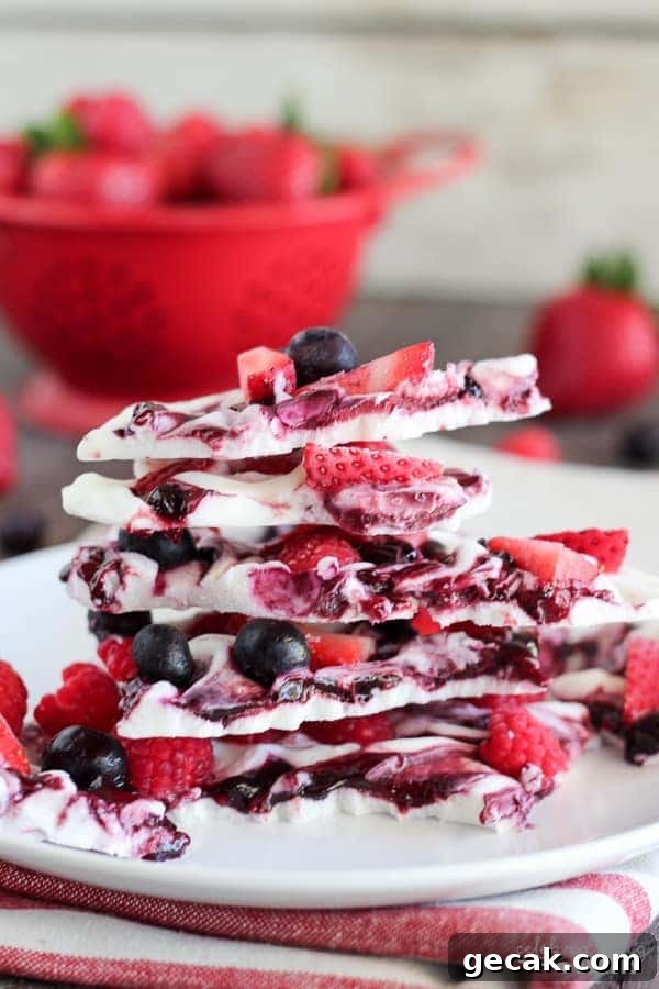 Pieces of berry yogurt bark stacked on top of each other - After School Snacks