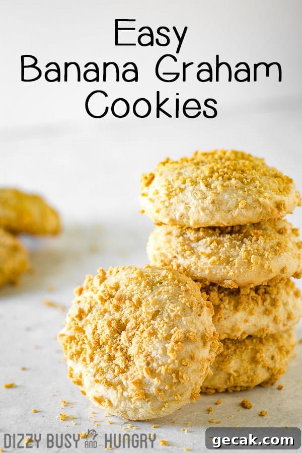 Side view of banana cookies stacked on each other on a white surface. 