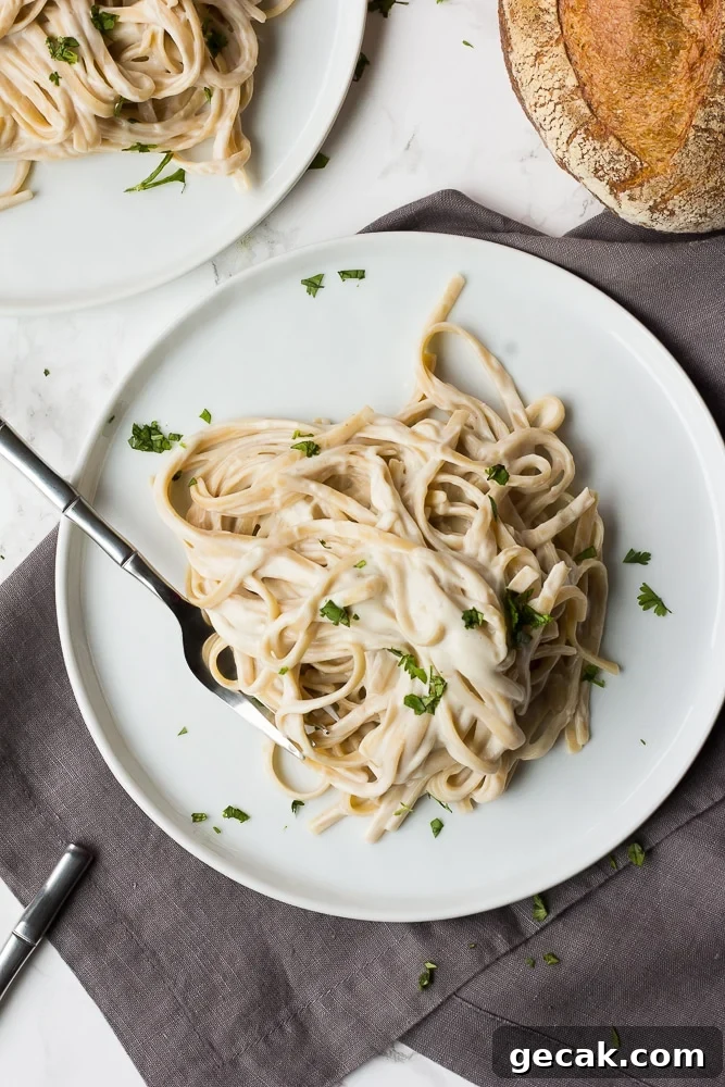 vegan alfredo fettucine on two plates