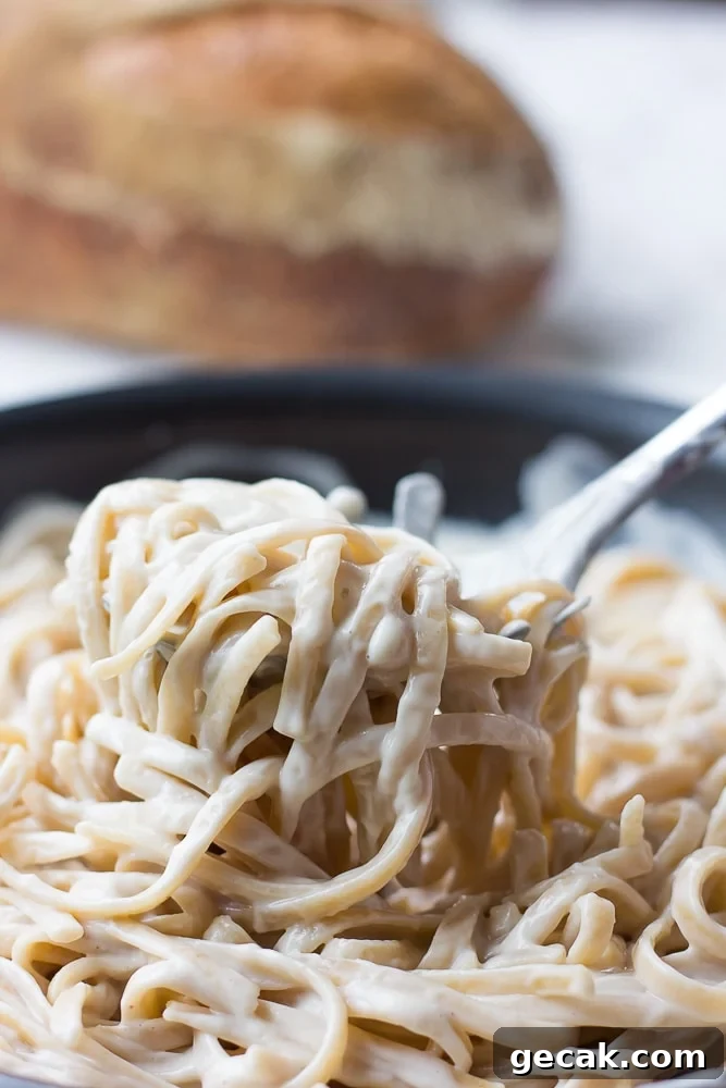 vegan alfredo sauce with fettucine on a fork