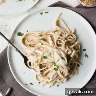 vegan alfredo fettucine on two plates