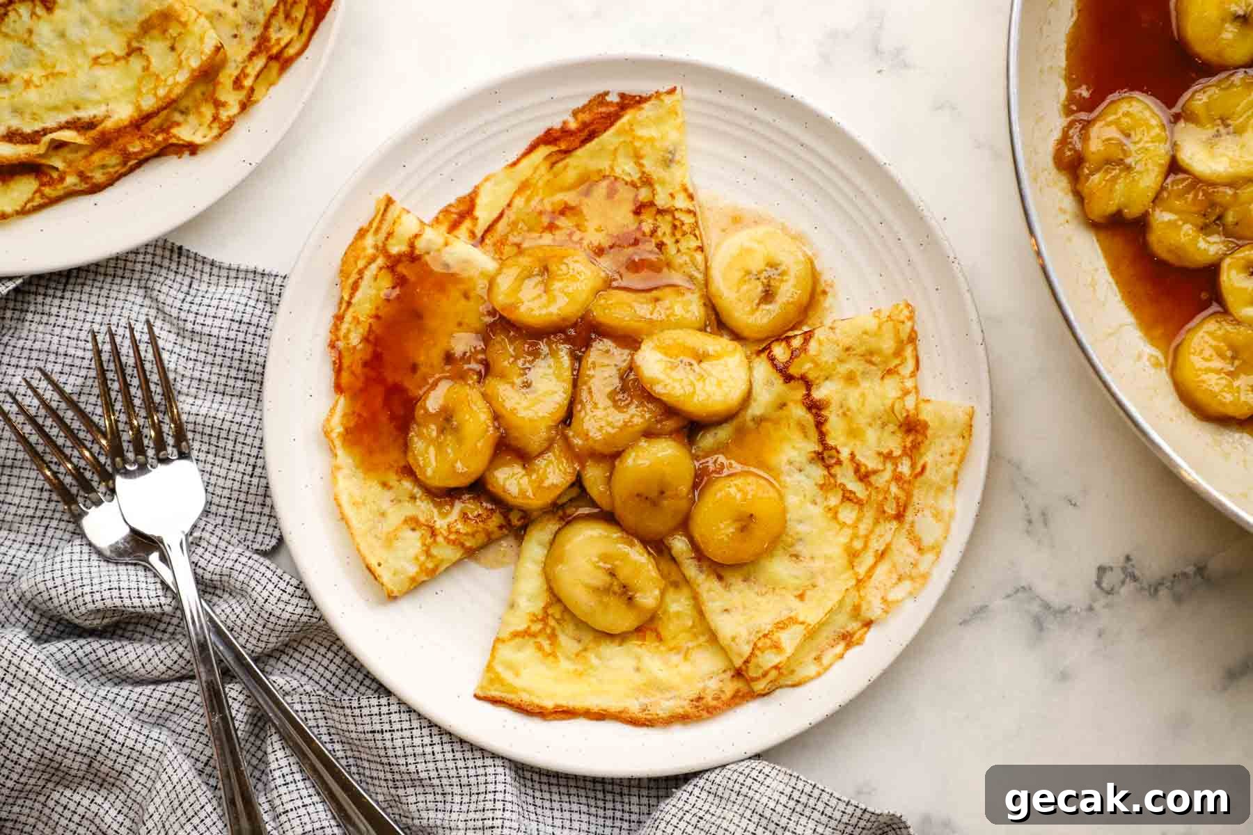 overhead view of a plate of banana foster crepes