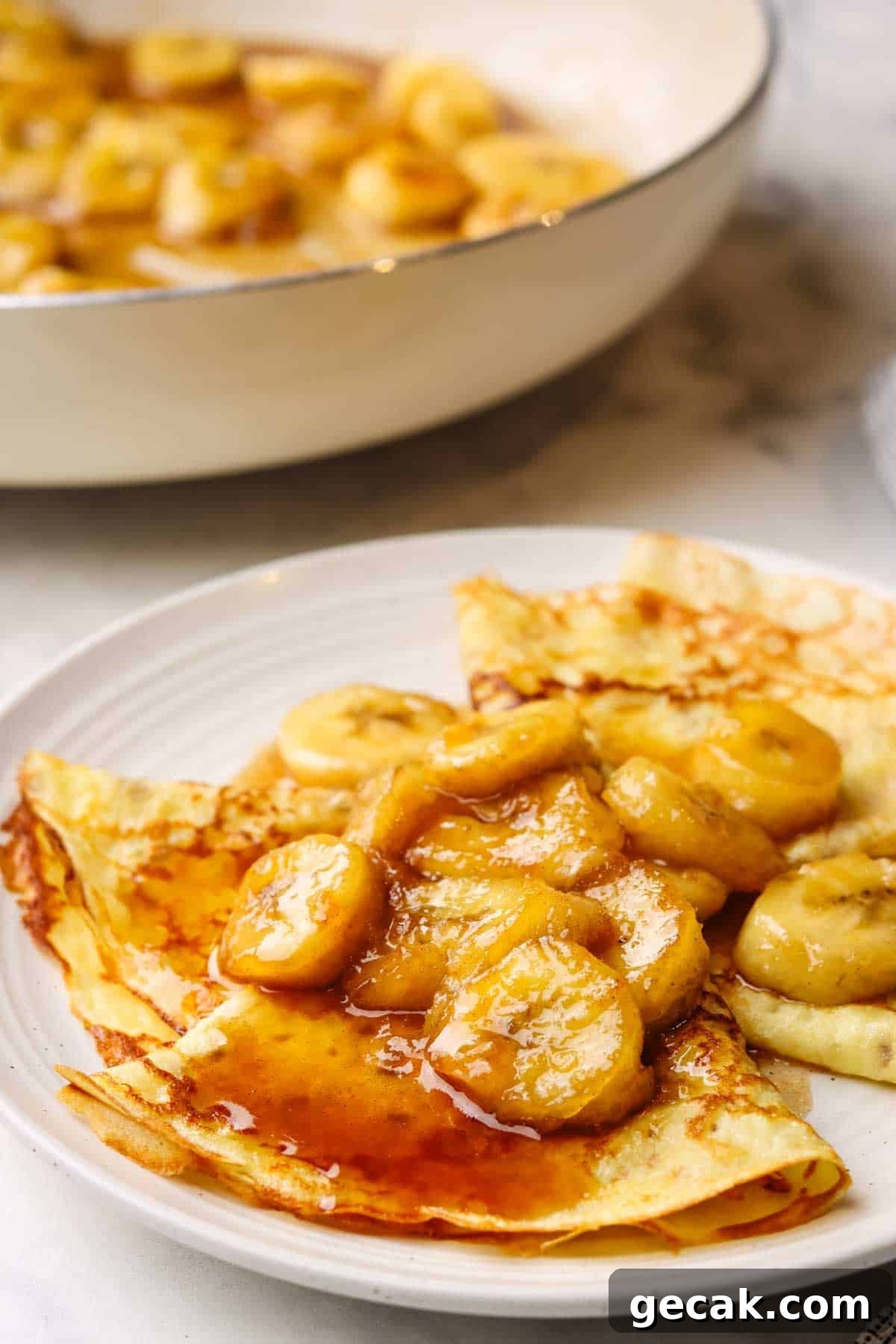 a plate of banana foster crepes
