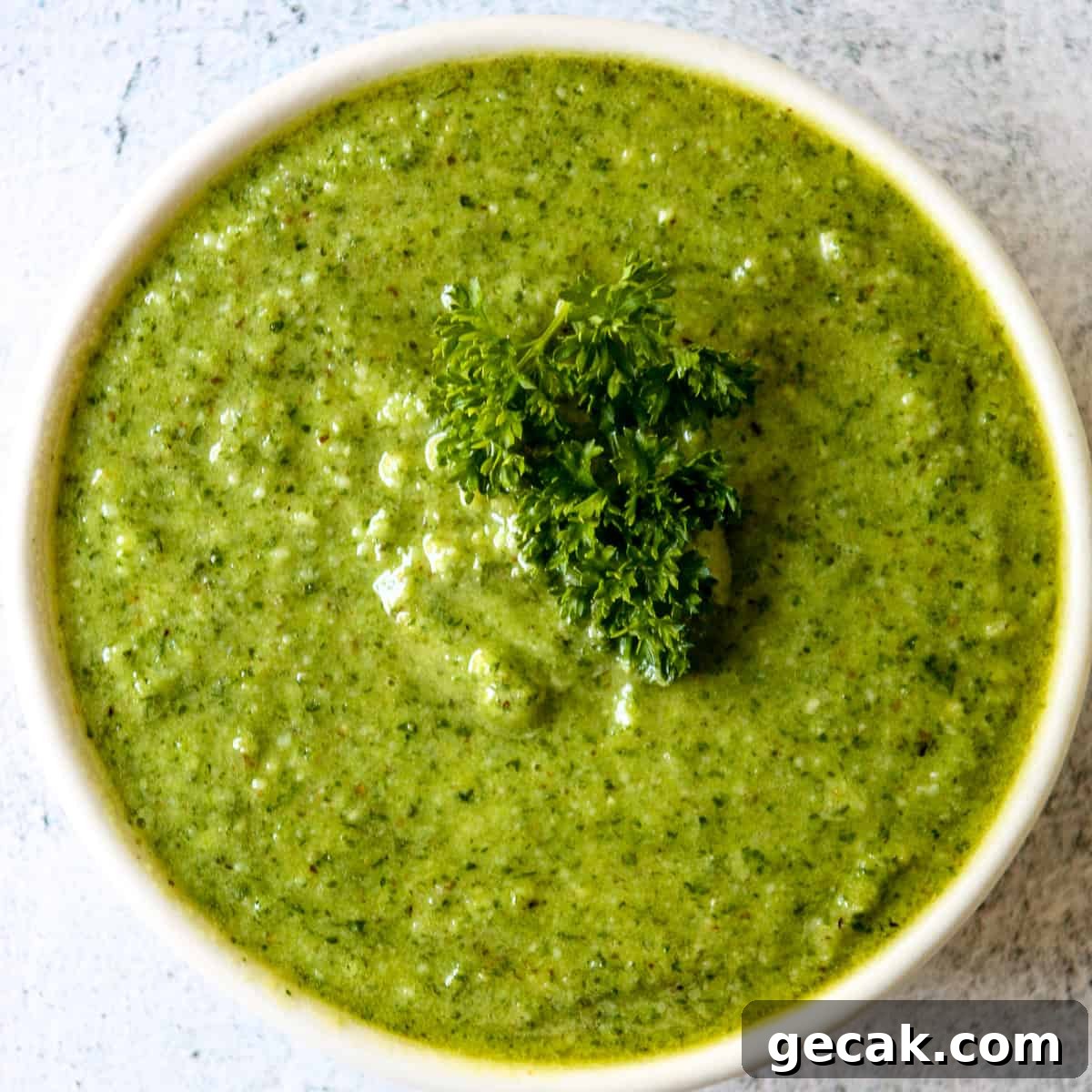 Parsley and Walnut Pesto Recipe: Fresh Homemade Sauce 2 Bright green parsley pesto in a white dish, garnished with a sprig of parsley.