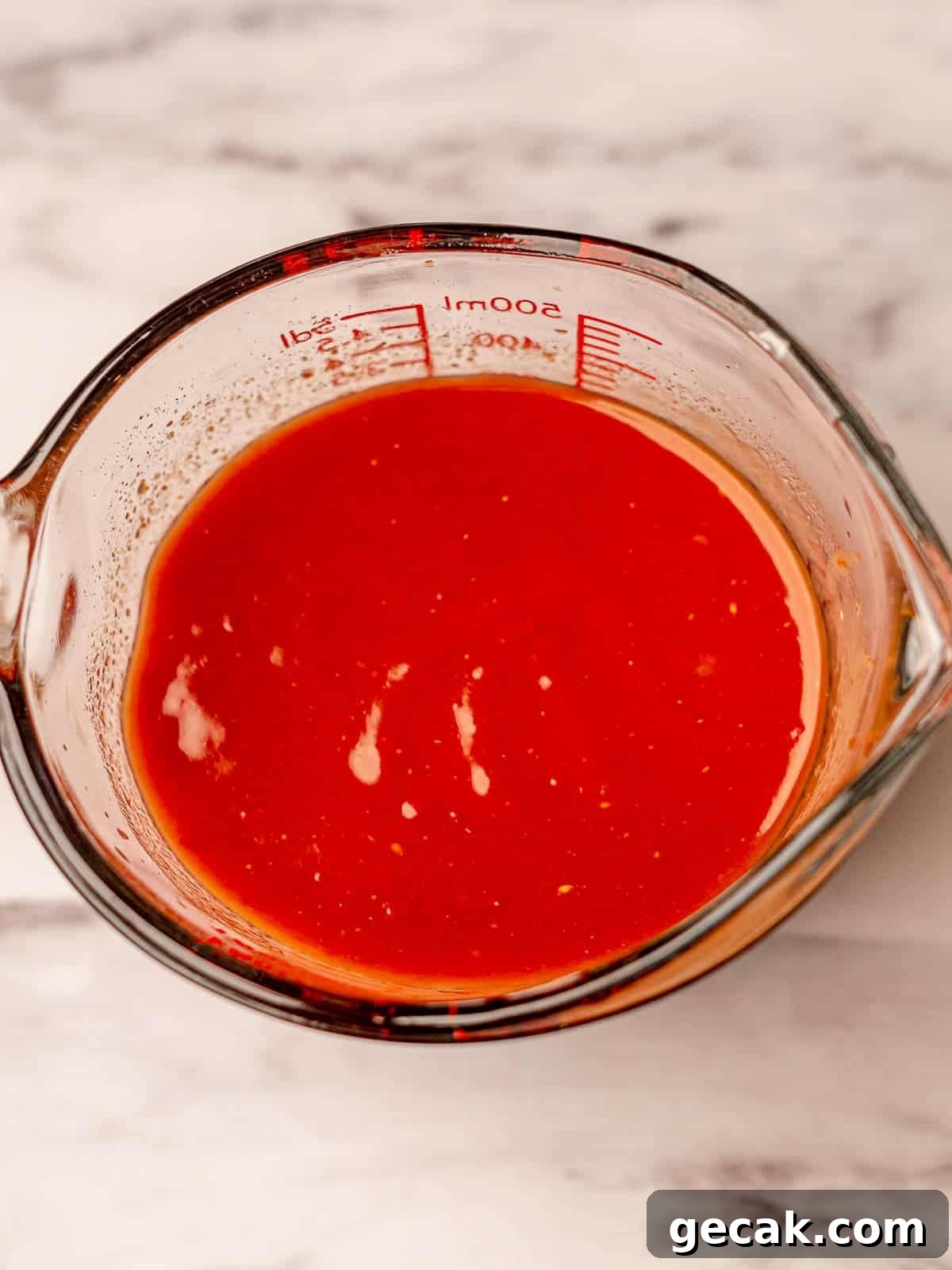 Sloppy joe sauce in a measuring cup.