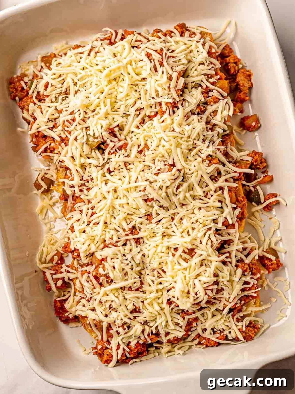 Shredded cheese on sliders.