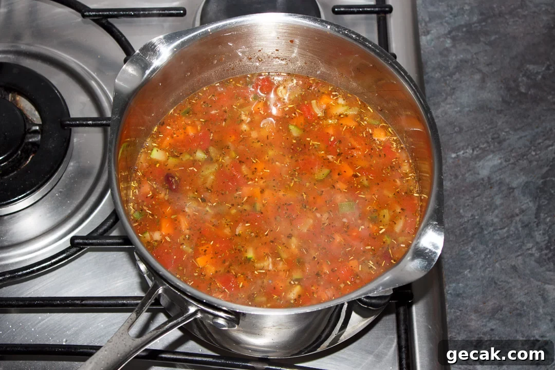 Minestrone soup simmering in a large saucepan