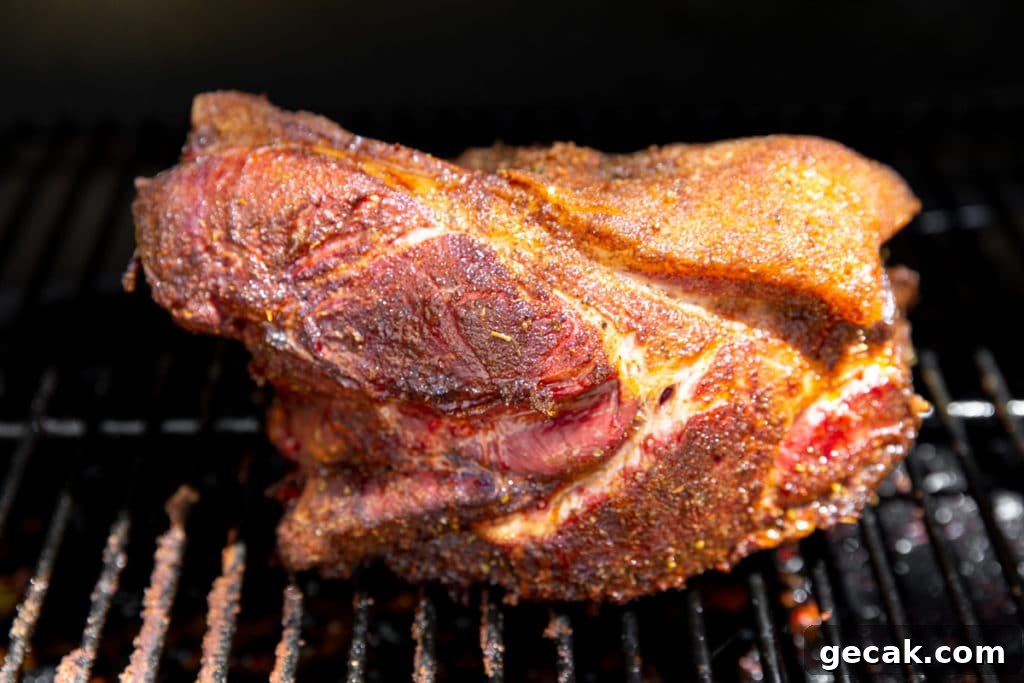Pork shoulder on a Traeger grill after cooking.